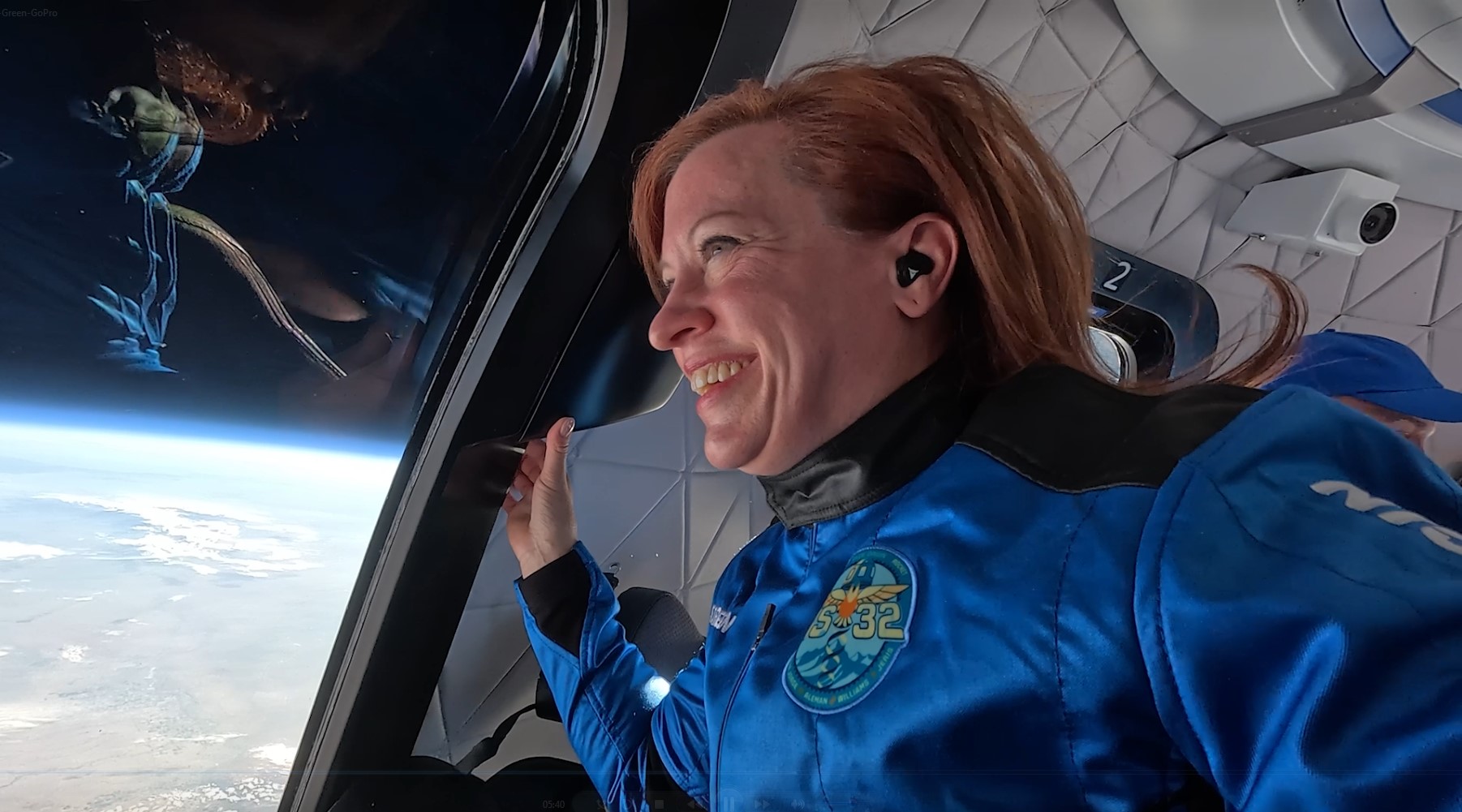 Dr. Green looks out into space with joy on her face.